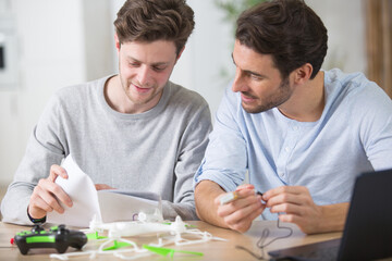 two male friends assembling a drone