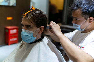 Life in Asia under pressure during novel Coronavirus, Omicron.  Caucasian male and Chinese...