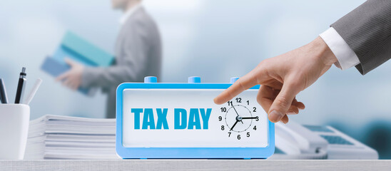 Businessman pointing at tax day reminder