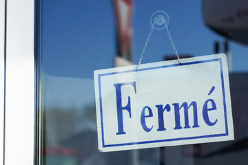 closed french text means ferme on door boutique text sign board on windows shop restaurant cafe store signboard