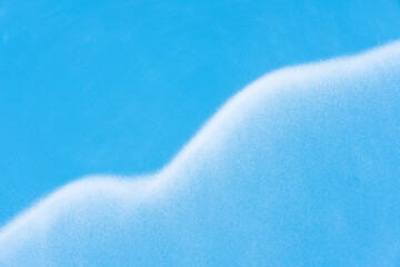 Blue wall texture background with white cloud fragment. Spray painted abstract backdrop. White...