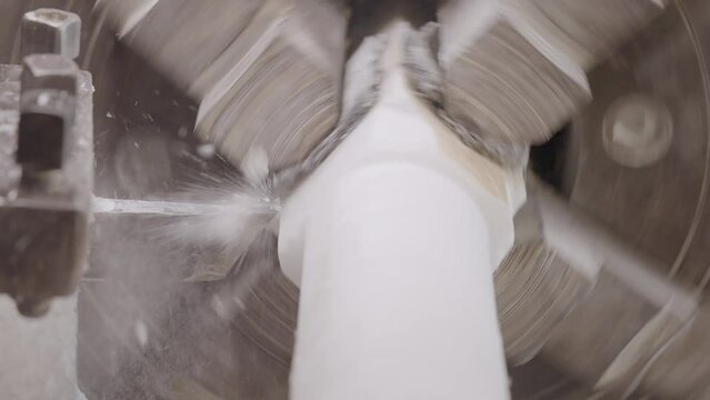 Close up gimbal shot of machine grinding piece of Makrana marble
