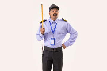 Portrait of Security guard standing with stick in his hand