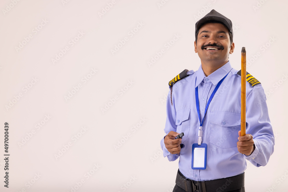 Wall mural Portrait of Security guard with whistle and stick in his hands