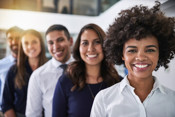 Smiles won through success. Portrait of a team of happy businesspeople standing behind each other in the office.