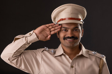 Close-up portrait of an Indian policeman saluting
