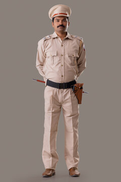 Portrait Of An Indian Policeman Standing With Hands Behind Back