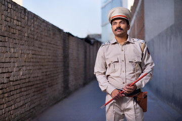 Portrait of an Indian policeman while on duty - obrazy, fototapety, plakaty