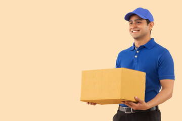 Portrait of a courier delivery boy with holding cardboard box in hand
