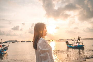 Summer Vacation. Smiling Asian women relaxing and standing, walking on the beach Vung Tau, so happy...