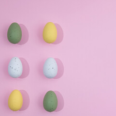 Fototapeta na wymiar Pattern Easter eggs of different colors with slight shadows on a pink background with copy space. minimal Easter scene.