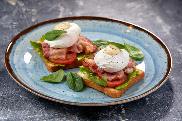 toasts with poached egg and bacon