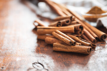 Dry cinnamon sticks on wooden table. Cinnamon spice.
