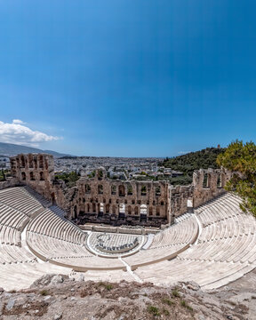 Herodeion ancient theater and Athens city view under crystal clear blue sky, Greece