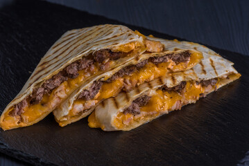 Quesadilla with beef. Tortilla, beef, cheese, white onion, cheese sauce.