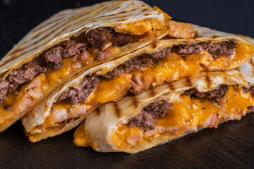 Quesadilla with beef. Tortilla, beef, cheese, white onion, cheese sauce.