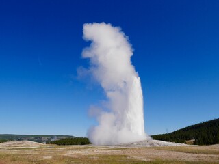 Old Faithful erupting. Yellowstone National Park, Wyoming, USA.