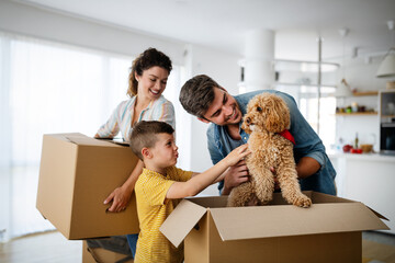 Husband and wife and their son with pet moving in new home.