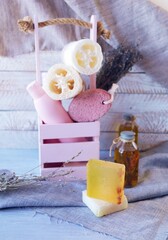 Hygiene products for body care and cleanliness, healthy oils and tinctures, a bouquet of lavender flowers in a box, on a wooden background, spa, natural ingredients