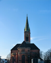 Church tower with clock and blue sky