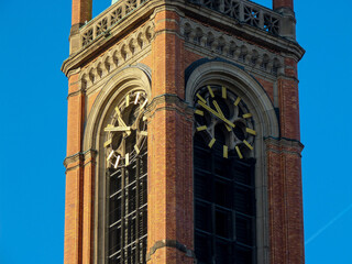 Church tower with clock and blue sky