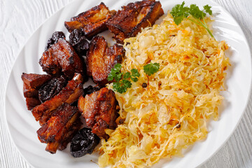 braised sauerkraut with pork and prunes on plate