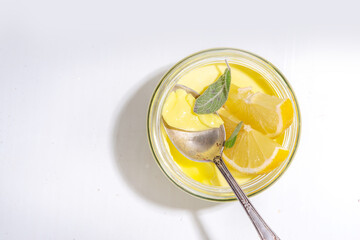 Lemon panna cotta dessert with fresh lemon wedges and sage leaves. Yellow citrus fruit panna cotta...