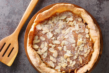English dessert Bakewell Pudding cake with raspberry jam and filling of egg and almond paste close-up on the table. horizontal top view from  above