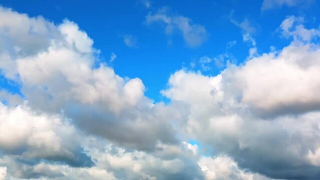 White clouds in the blue sky background. Timelapse. Sunny day. Partly cloudy. Weather forecast. Sunlight. Cloudscape. Wind move. Cyclone and anticyclone. HD video footage. Atmosphere pattern. Heavens.