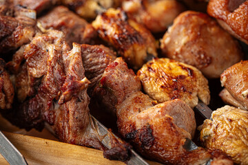 Assorted grilled caucasian shashlik kebabs on the wooden board