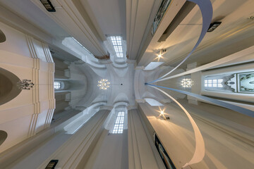 interior dome and looking up into a old gothic or baroque catholic  church ceiling with columns