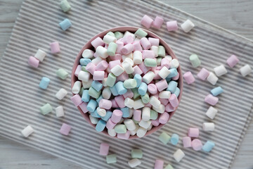 Rainbow Fruity Mini Marshmallows in a Pink Bowl, top view. Flat lay, overhead, from above.