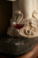 Red cocktail glass on a marble bar counter