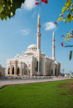 Beautiful Al Noor Mosque located at Sharjah corniche. A view of a Masjid against blue sky.
