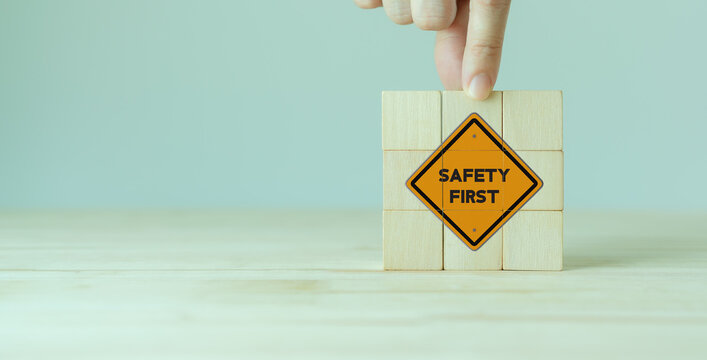 Safety first symbols, work safety, caution work hazards, danger surveillance, zero accident concept. Wooden cubes with smart grey background. Employees safety awareness at workplace. Safety banner.