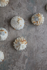 meringue on grey background. meringue is a dessert made of whipped egg whites with sugar. Flat lay and copyspace