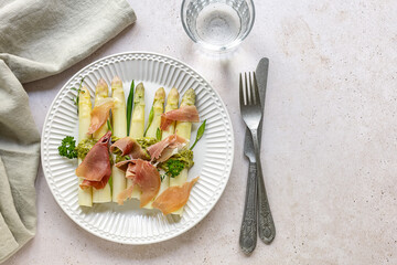 White asparagus with italian pesto and prosciutto ham. delicious dinner for spring season. traditional german dish. keto diet.