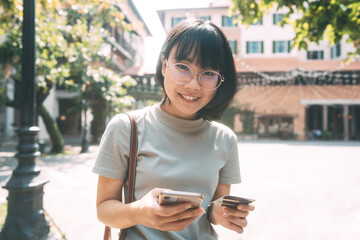 Young adult asian woman consumer using creadit card digital wallet on mobile phone