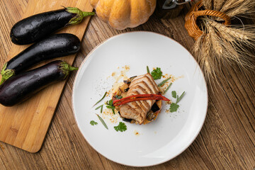 Eggplant dish in a restaurant on a wooden table
