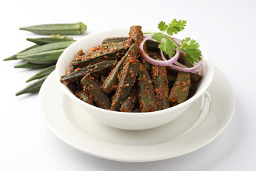 Bhindi masala, Bhindi kurkure or crunchy okra or ladies' fingers, a Rajasthani traditional dish served in a white ceramic bowl along with raw bhindi aside
