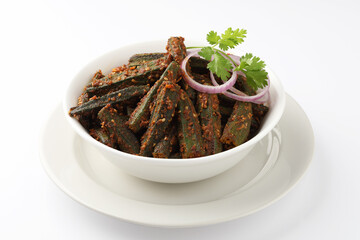 Bhindi masala, Bhindi kurkure or crunchy okra or ladies' fingers, a Rajasthani traditional dish served in a white ceramic bowl along with raw bhindi aside