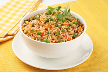Schezwan Fried Rice is a popular indo-chinese food served in a plate or bowl with authentic sausages. selective focus