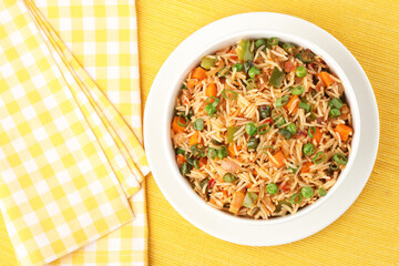 Schezwan Fried Rice is a popular indo-chinese food served in a plate or bowl with authentic sausages. selective focus