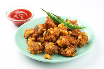 Crispy Corn pakora/pakoda, bhajji, Bhaji, bajji or pattice . served with tomato ketchup & mint chutney