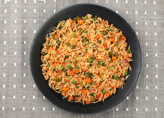 Schezwan Fried Rice is a popular indo-chinese food served in a plate or bowl with authentic sausages. selective focus - obrazy, fototapety, plakaty