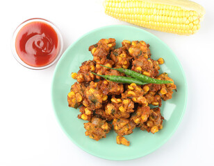 Crispy Corn pakora/pakoda, bhajji, Bhaji, bajji or pattice . served with tomato ketchup & mint chutney