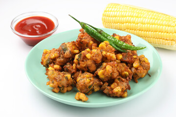 Crispy Corn pakora/pakoda, bhajji, Bhaji, bajji or pattice . served with tomato ketchup & mint chutney