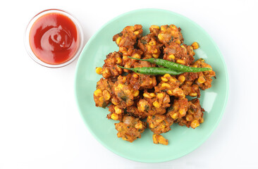 Crispy Corn pakora/pakoda, bhajji, Bhaji, bajji or pattice . served with tomato ketchup & mint chutney