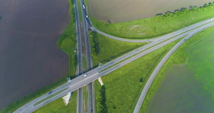 Traffic interchange top view. Ato go on the highway top view. Flying over a road junction. Cars drive along the highway outside the city