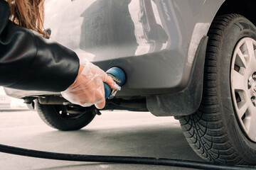 Filling car petrol. Pump gas fuel at gasoline oil station for nozzle tank. Black handle of the...